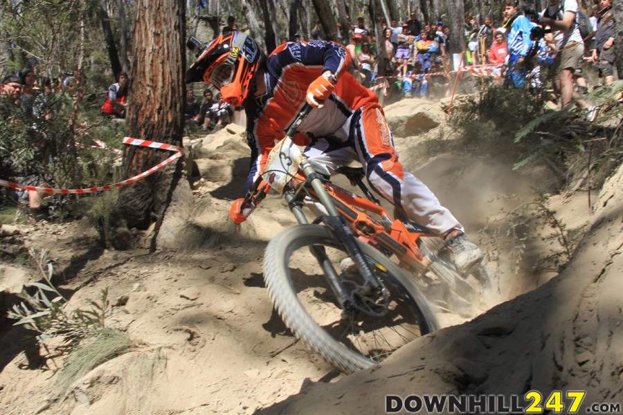 Rick Boyer carves a wave of dust late in his race run, moments before spectators are sprayed with dust.