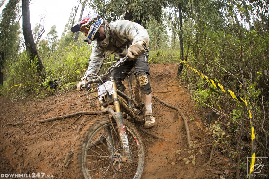 Max Kreuzer navigates some slippery roots that caught many riders out. Sunday brought only some relief.