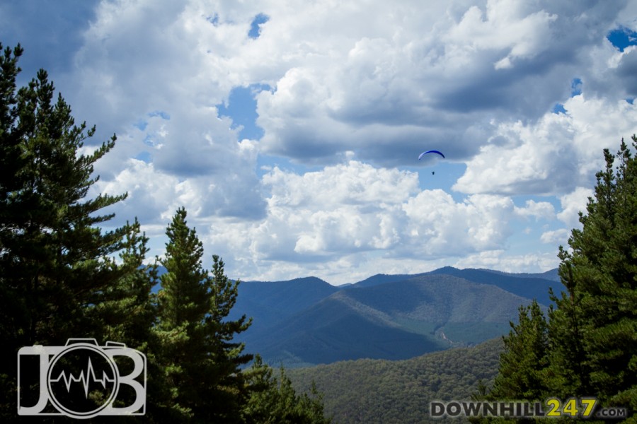 Outside of the forest the view was picturesque.  A beautiful summer alpine scene with dozens of paragliders!