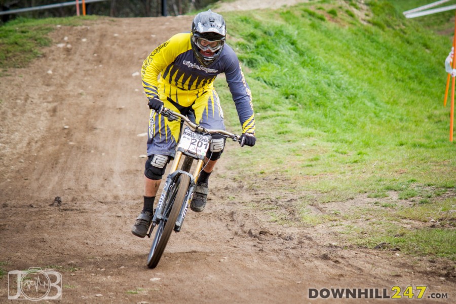 Under 19s reigning champion, Joel Willis sprints to the finish, spent after a blistering fun. 