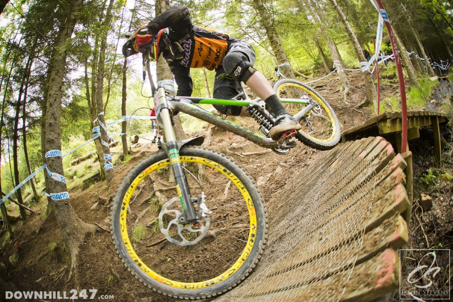 Tegan Molloy pushes over the slippery wooden feature part way through the woods