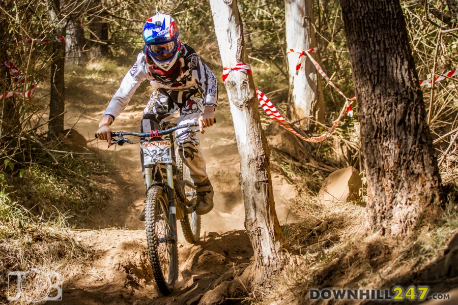 Chris Clark carrying speed into the main rock garden during practice, light and smooth through the loose surface.