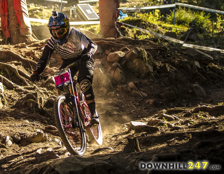 Jill Kintner in the early morning sunshine and dust towards the bottom of the track.