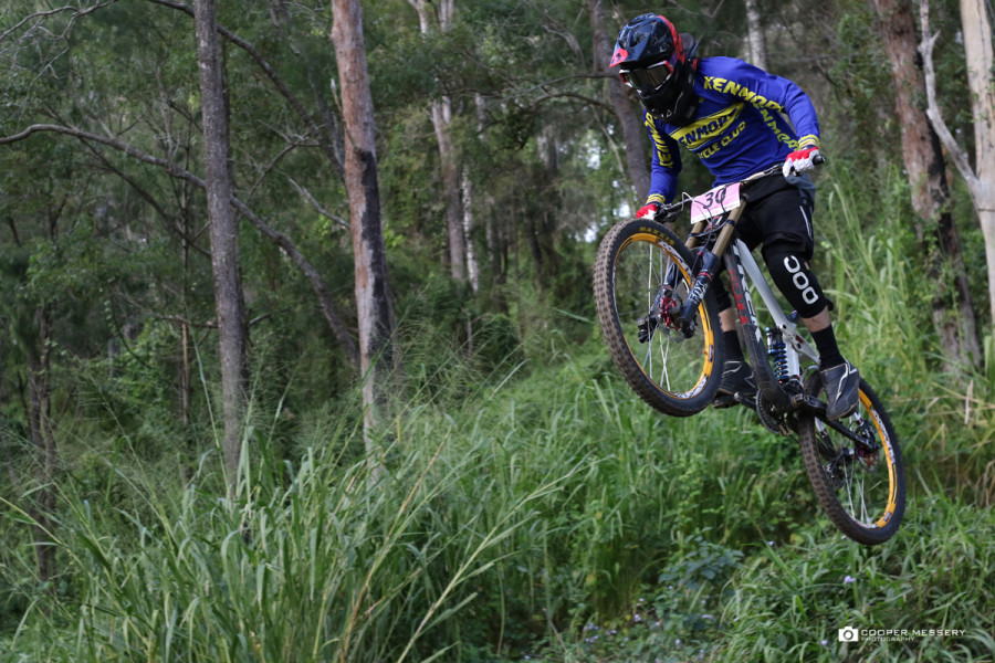 The a�?pencil techniquea�� was pretty common off this lip as riders tried to get a spotting on their landing before railing the next berm and shooting off down the track.