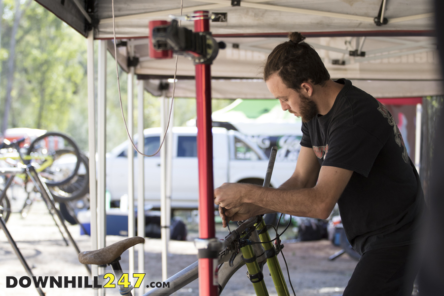 Sam Fraser making a few bike setup changes prior to hitting the track for a few more practice runs on Sunday before the racing started.