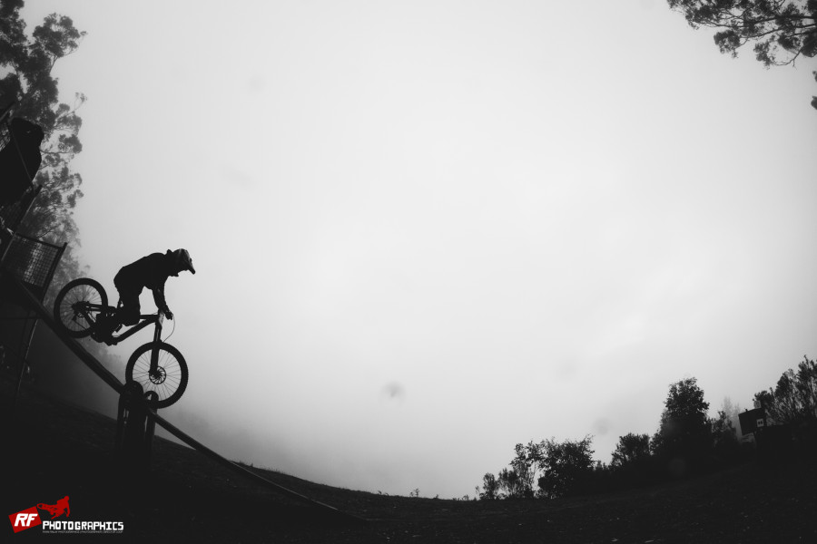 The riders set off into fog at the top of the hill.