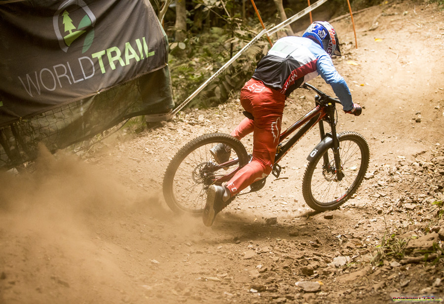 Racing doesn't always go as planned - Finn Iles coming out of the rock garden with his feet no where near the pedals!